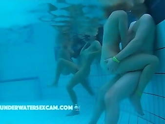 See these mischievous nubile babes delight each other in a public pool, no shame!